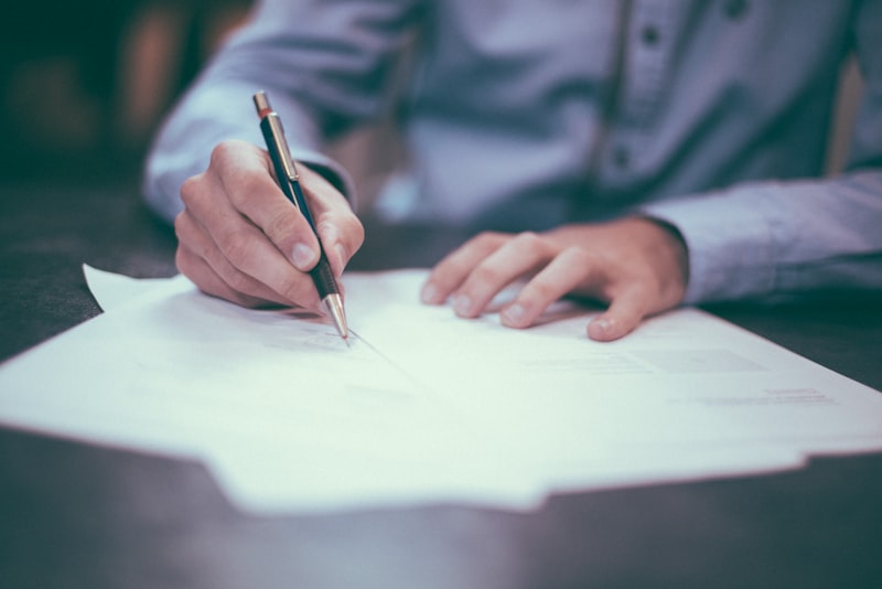 A person writing on paperwork related to an evaluation